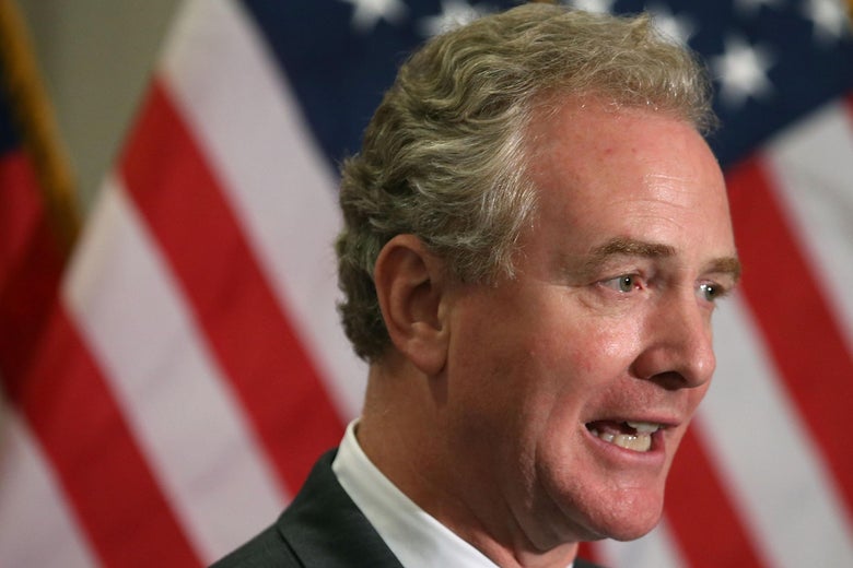 Sen. Van Hollen speaking in front of an American glag
